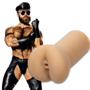 Man in leather outfit beside adult toy