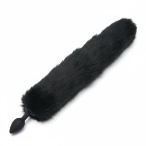 Black furry tail plug on white background.