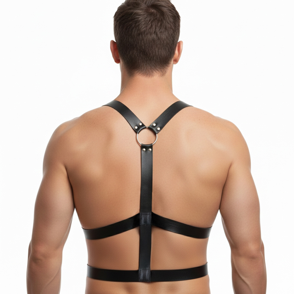 Man wearing black leather harness from behind.