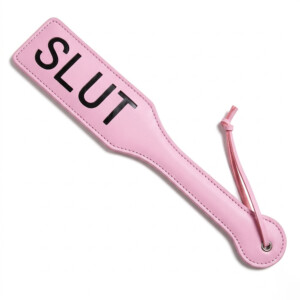 Pink leather paddle with text design.