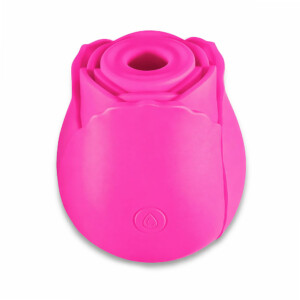 Pink rose-shaped silicone device on white background