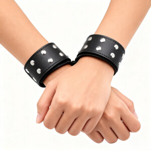 Hands wearing studded leather wrist cuffs