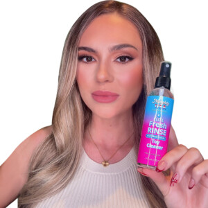 Woman holding antibacterial toy cleaner bottle