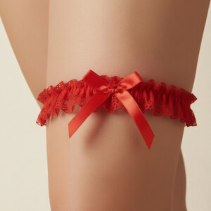Red lace garter with bow on leg