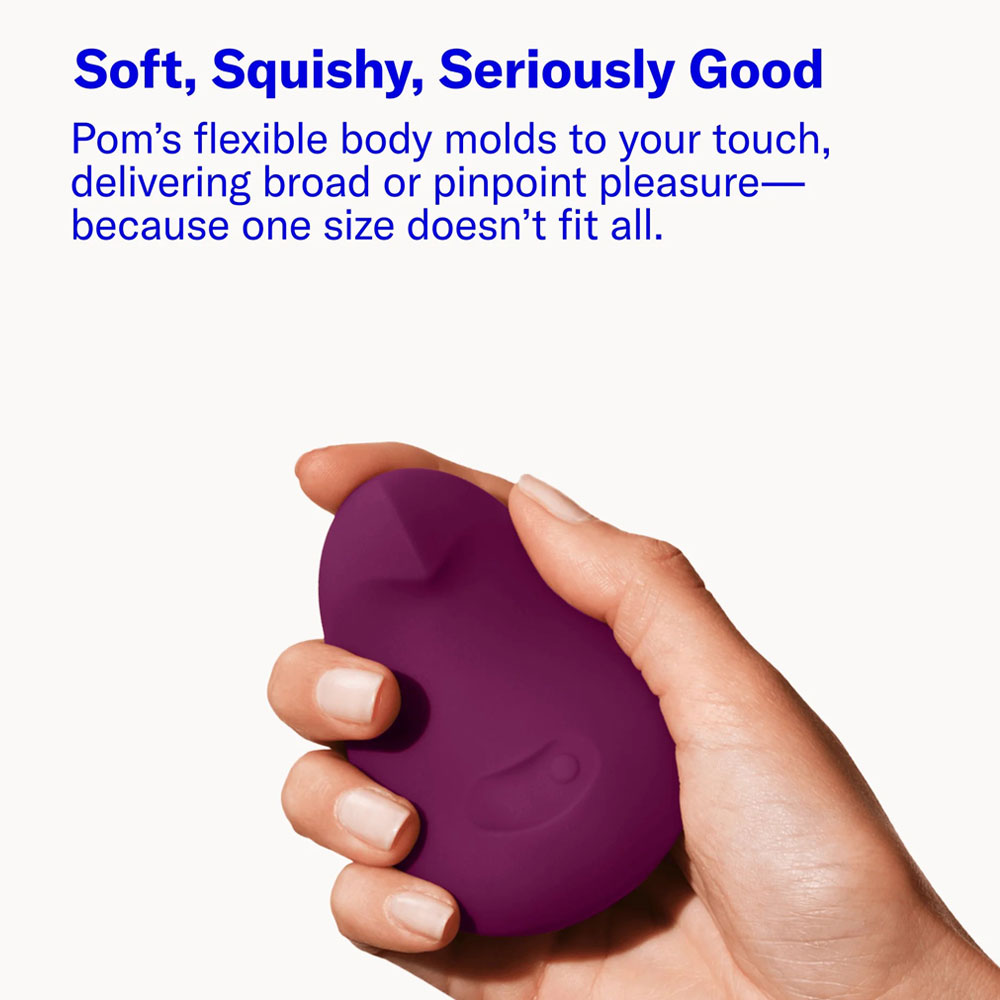 Hand holding purple, flexible, ergonomic massager.