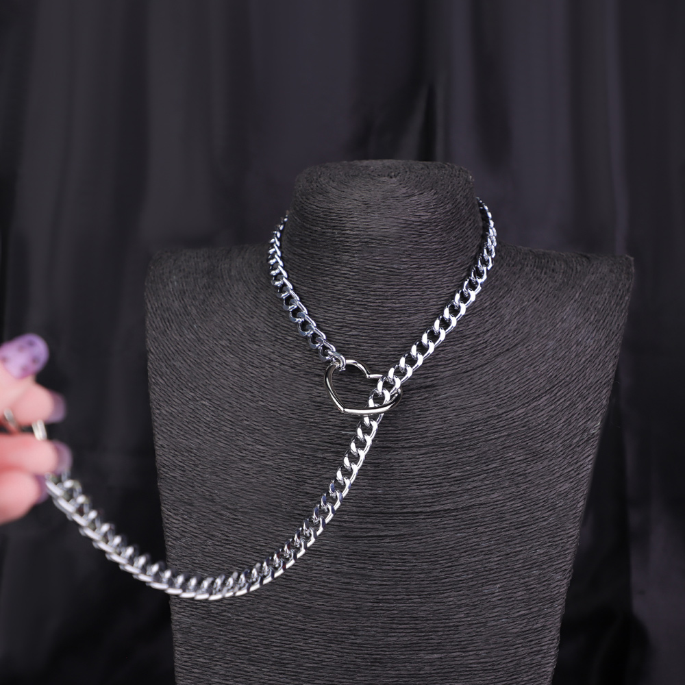 Silver heart-shaped chain necklace on display bust.