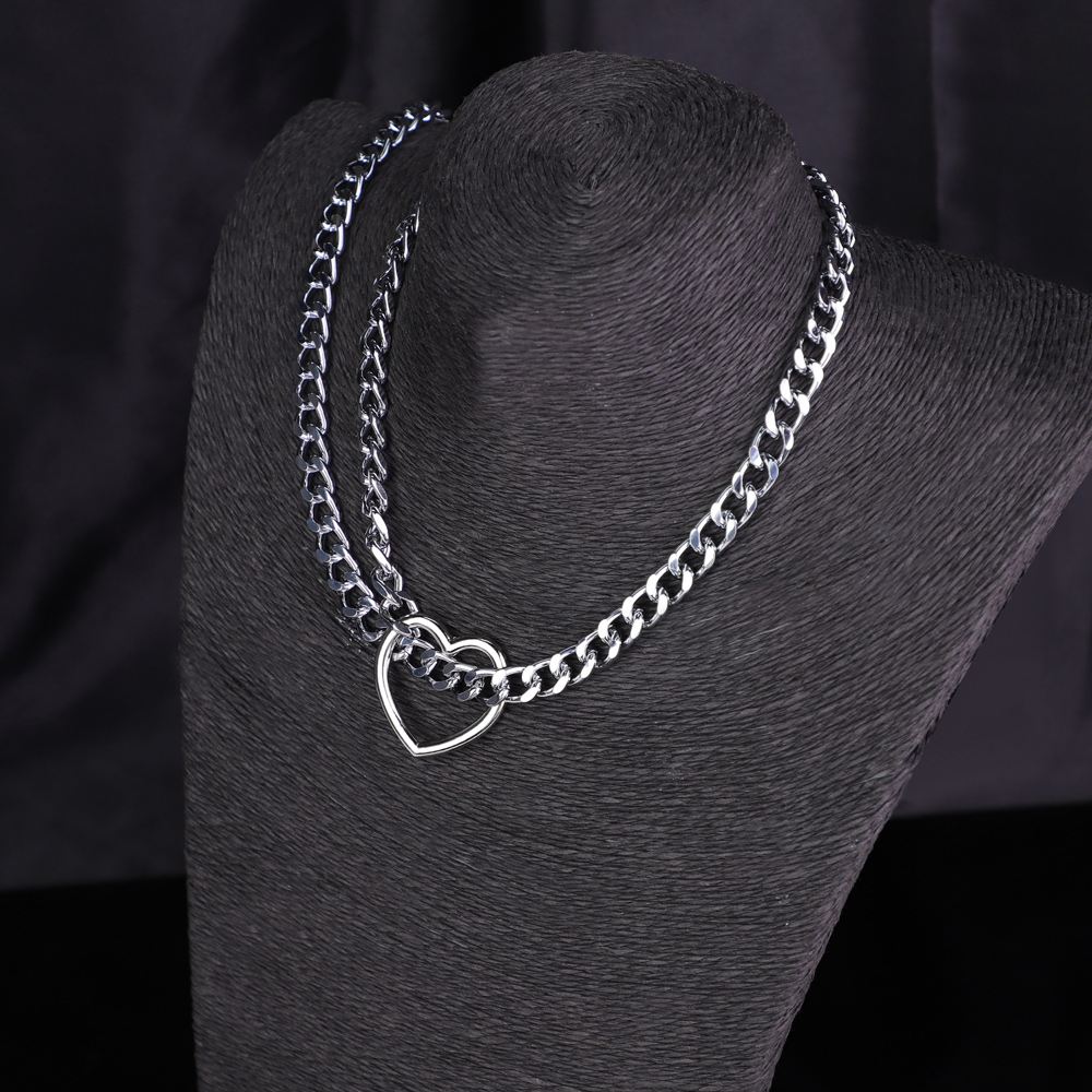 Silver chain necklace with heart pendant display.