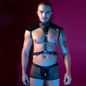Man modeling black leather harness under neon lighting