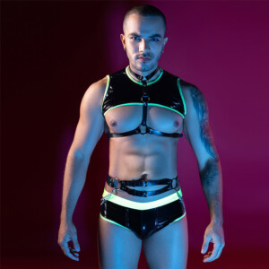 Man posing in neon-trimmed black harness and briefs