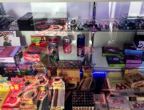 Adult toys on shelves at Romantic Depot Manhattan including dildos, penis sleeves, and strap-ons in various colors and sizes