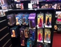 Wide shot of adult toy section with anal plugs, cock rings, and vibrating panties on display at Romantic Depot Manhattan