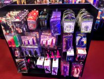 Wall display of realistic dildos, anal toys, and cock rings at Romantic Depot Manhattan adult toy store