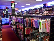 Wall of best-selling adult toys including vibrating cock rings, realistic dildos, and strap on vibrators at Romantic Depot Manhattan