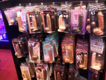 Romantic Depot Manhattan display showcasing a variety of vibrators and adult novelties arranged neatly on retail shelves.