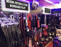 Bondage gear display at Romantic Depot Manhattan featuring BDSM essentials like floggers, paddles, blindfolds, and restraints for kink and fetish play.