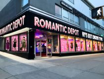 Romantic Depot storefront on Broadway with bold signage ‘NY’s Best Lingerie Store’, window mannequins, and Free Spin display at store entrance