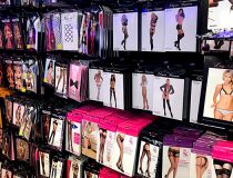 Lingerie wall at Romantic Depot Manhattan featuring sexy lingerie sets, lace bras, and intimate clothing