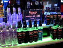 Romantic Depot Manhattan display of personal lubricants and massage lotions including water-based, silicone, flavored, and warming lubes for enhanced intimacy.