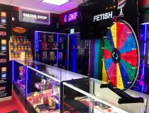 Romantic Depot Manhattan smoke shop section featuring hookahs, vape products, glass pipes, and CBD accessories on lit shelves.