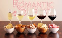 Romantic Depot wine and snack tasting setup with white and red wines paired with chips, crackers, and charcuterie