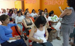 Romantic Depot community event with women attending an educational class in a bright orange room