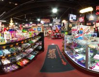 Interior view of Romantic Depot Bronx Megastore featuring adult toys, lingerie, gifts, and health products in a vibrant, well-lit showroom.