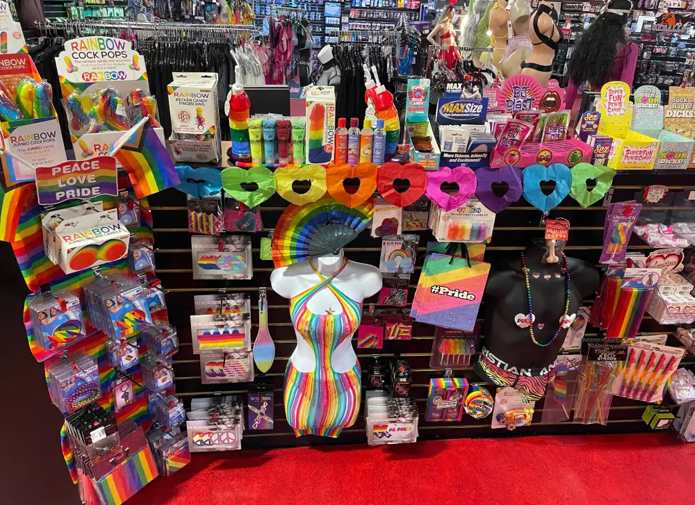Pride Month retail display at Romantic Depot featuring rainbow lingerie, LGBTQ+ gifts, novelty items, and colorful adult toys