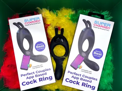 Super Charged app-based vibrating cock ring for couples – world’s best cock ring displayed with rainbow feather boa for Pride. Compatible with remote control and Love Spouse app.